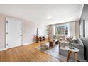 Bright living room featuring hardwood floors, a gray sofa, modern decor, and natural light at 1321 E 10Th Ave # 4, Denver, CO 80218