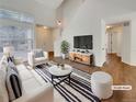 Bright living room featuring vaulted ceilings, natural light, and stylish decor at 5966 S Winnipeg St, Aurora, CO 80015