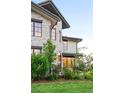 Well-manicured lawn and beautiful landscaping enhance the curb appeal of this home at 5455 E Cedar Ave, Denver, CO 80246