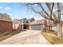 House exterior showcasing brick and gray siding, driveway and landscaping at 7079 S Locust Pl, Centennial, CO 80112