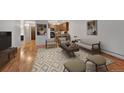 Sunlit living area seamlessly connects to the kitchen with ample seating and modern décor at 6930 E Girard Ave # 106, Denver, CO 80224