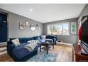 Stylish living room featuring a comfortable blue sectional sofa, and modern decor at 4827 Meade St, Denver, CO 80221