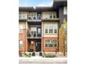 Multi-story home with a mix of brick and siding, featuring balconies and lush landscaping at 181 S Monaco Pkwy, Denver, CO 80224