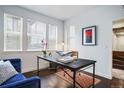 Bright office space with large windows, modern desk, and comfortable seating area at 181 S Monaco Pkwy, Denver, CO 80224