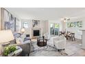 Bright living room featuring a fireplace, modern furnishings and lots of natural light at 7680 Depew St # 1404, Arvada, CO 80003