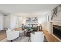 Cozy living room featuring a fireplace, neutral decor, and plenty of natural light at 7680 Depew St # 1404, Arvada, CO 80003