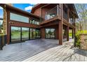 Beautiful home showcasing a large back deck and mountain views through sliding glass doors and large windows at 10895 Pheasant Run, Littleton, CO 80125