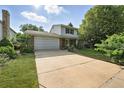 Inviting two-story home with a spacious driveway, attached garage, and a lush green lawn at 1341 S Blackhawk Way, Aurora, CO 80012