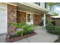 Close-up view of a welcoming front porch with red brick and a decorative white front door at 1341 S Blackhawk Way, Aurora, CO 80012