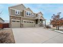 Beautiful home with a large driveway, three-car garage, stone accents, and professionally landscaped yard at 10003 Atlanta St, Parker, CO 80134