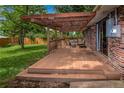 Spacious back deck with pergola, outdoor seating, and brick exterior at 3071 S Jasmine St, Denver, CO 80222