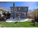 Back exterior featuring a spacious patio, furniture set and landscaped yard at 21710 Silver Meadow Ln, Parker, CO 80138