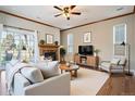 Comfortable living room with fireplace, ceiling fan, hardwood floors and natural lighting at 21710 Silver Meadow Ln, Parker, CO 80138