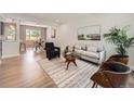 Spacious living room featuring modern furnishings, light wood floors, and lots of natural light at 1245 Troy St, Aurora, CO 80011