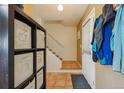 Functional entryway with a coat rack, storage cubes, and tile flooring at 2645 Osceola St, Denver, CO 80212