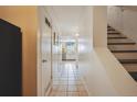 Inviting hallway with tile flooring leading to the kitchen, and stairs on the right at 2645 Osceola St, Denver, CO 80212