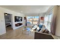 Bright and airy living room with large windows, stylish furniture, and hardwood floors at 6005 E Iowa Ave, Denver, CO 80224