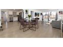 Open concept living and dining area with hardwood floors, modern furniture and great light at 6005 E Iowa Ave, Denver, CO 80224