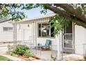 Inviting front porch with chairs, creating a cozy outdoor seating area at 1634 S King St, Denver, CO 80219
