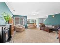 Spacious living room boasts large windows, a fireplace, and carpeted floors throughout at 7745 Grant St, Denver, CO 80229