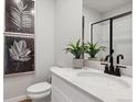 Stylish powder room features modern fixtures, elegant decor, and a sleek, glass-enclosed shower at 1415 Orchard St, Brighton, CO 80601
