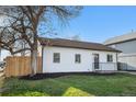 This home features a well-kept lawn, black trim, and a inviting front porch at 3073 S Elati St, Englewood, CO 80110