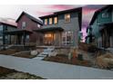 Stylish gray home with a inviting front porch and landscaped yard, nestled in a vibrant neighborhood at 6052 N Malta St, Aurora, CO 80019