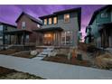 Charming home featuring a well-manicured yard and inviting front porch with seating area at 6052 N Malta St, Aurora, CO 80019