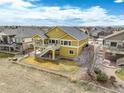 Two-story home showcasing a large deck, and landscaping for outdoor enjoyment at 15004 Verbena St, Thornton, CO 80602