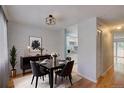 Cozy dining room with modern black table set and decorative pendant lighting, adjacent to the bright kitchen at 1060 S Parker Rd # 9, Denver, CO 80231