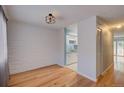 Bright dining room with hardwood floors and white brick walls, conveniently located near the kitchen at 1060 S Parker Rd # 9, Denver, CO 80231