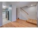 Entryway featuring hardwood floors, staircase, and access to a modern kitchen at 1060 S Parker Rd # 9, Denver, CO 80231