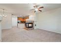 Bright open-concept living room features a fireplace, ceiling fan and neutral tones at 9907 Martin Luther King Blvd # 103, Denver, CO 80238
