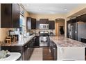 Modern kitchen with stainless steel appliances, spacious countertops, and ample cabinet space at 21088 Randolph Pl, Denver, CO 80249