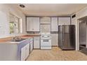 A kitchen featuring ample cabinet space and stainless steel refrigerator in a spacious layout at 1000 Salem St, Aurora, CO 80011
