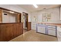 A kitchen featuring a breakfast bar and views into an adjacent room at 1000 Salem St, Aurora, CO 80011