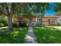 Charming brick ranch home with a well-maintained front yard and cozy front porch at 10839 Carrol Ln, Northglenn, CO 80233