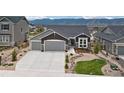 Charming gray home with a three car garage and beautifully xeriscaped front yard at 16840 New Autumn Dr, Monument, CO 80132