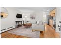 Cozy living room featuring a comfortable couch, media center, and an open floor plan at 558 N Washington St # 305, Denver, CO 80203