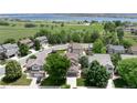 Scenic aerial view of a quiet neighborhood with lush greenery and a glimpse of the lake at 9610 S Dover Way, Littleton, CO 80127