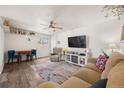 Open living area with hardwood floors and colorful rug at 1217 Osceola St, Denver, CO 80204