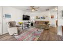 Comfortable living room featuring a plush sofa, a modern television, and stylish decor on hardwood floors at 1217 Osceola St, Denver, CO 80204