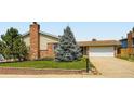 Charming home with brick and siding, a well-kept lawn, and a mature tree enhancing curb appeal at 6212 S Ash W Cir, Centennial, CO 80121