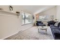 Inviting living room with a cozy seating area, piano, natural light, and neutral decor at 6212 S Ash W Cir, Centennial, CO 80121