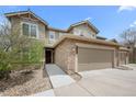 Beautiful townhouse with stone accents, attached garage, and a welcoming front entrance at 22062 E Irish Dr, Aurora, CO 80016