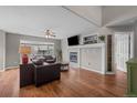 Cozy living room with fireplace, ceiling fan, and wood floors at 22062 E Irish Dr, Aurora, CO 80016