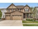 Charming two-story home with stone accents, a three-car garage, and a covered front porch at 2165 Summerlin Ln, Longmont, CO 80503