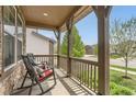 Relaxing front porch with rocking chairs and decorative pillows, perfect for enjoying the outdoors at 2165 Summerlin Ln, Longmont, CO 80503