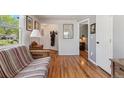 Bedroom featuring hardwood floors, futon, and a view into the home's hallway at 5445 Reed Ct, Arvada, CO 80002