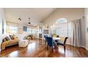 Comfortable living and dining area with hardwood floors, chandelier, and a cozy seating arrangement at 2266 S Kenton St, Aurora, CO 80014